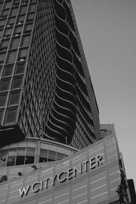 a black and white photo of the city center, inspired by Vivian Maier, unsplash contest winner, brutalism, spiraling upward, storefront, hunter hunter, concrete poetry