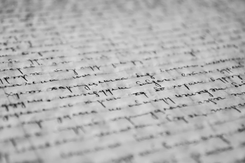 a piece of paper with writing on it, a black and white photo, by Adam Marczyński, pexels, letterism, parchment paper, lined paper, closeup photo, multiple stories