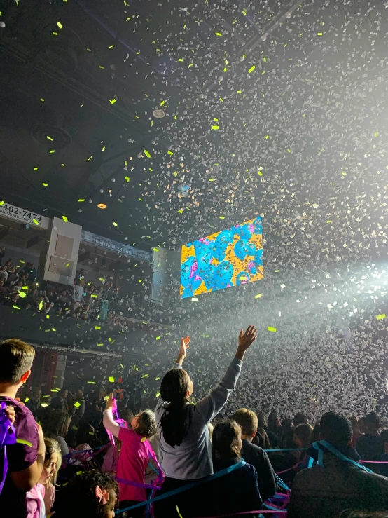 a crowd of people at a concert with confetti in the air, pokimane, 🚀🌈🤩, tie-dye, siggraph