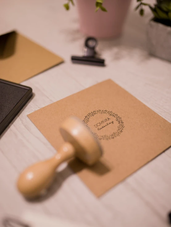 a rubber stamper sitting on top of a piece of paper, inspired by Okada Hanko, unsplash, private press, brown paper, wedding, product introduction photo, archival quality image