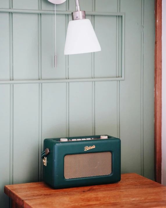 a radio sitting on top of a wooden table, by Sylvia Wishart, unsplash, rgb wall light, green and white, vertical wallpaper, replica model