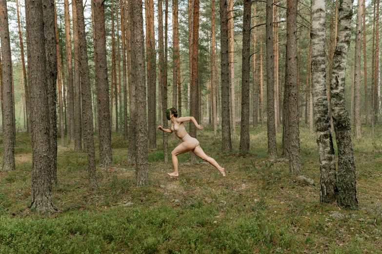 a naked woman running through a forest, by Emma Andijewska, unsplash, renaissance, summer siberian forest taiga, performance, ignant, viktor orban in a forest