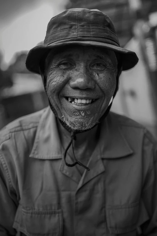 a black and white photo of a man wearing a hat, pexels contest winner, sumatraism, large smile, made of tar, vietnamese woman, medium format. soft light