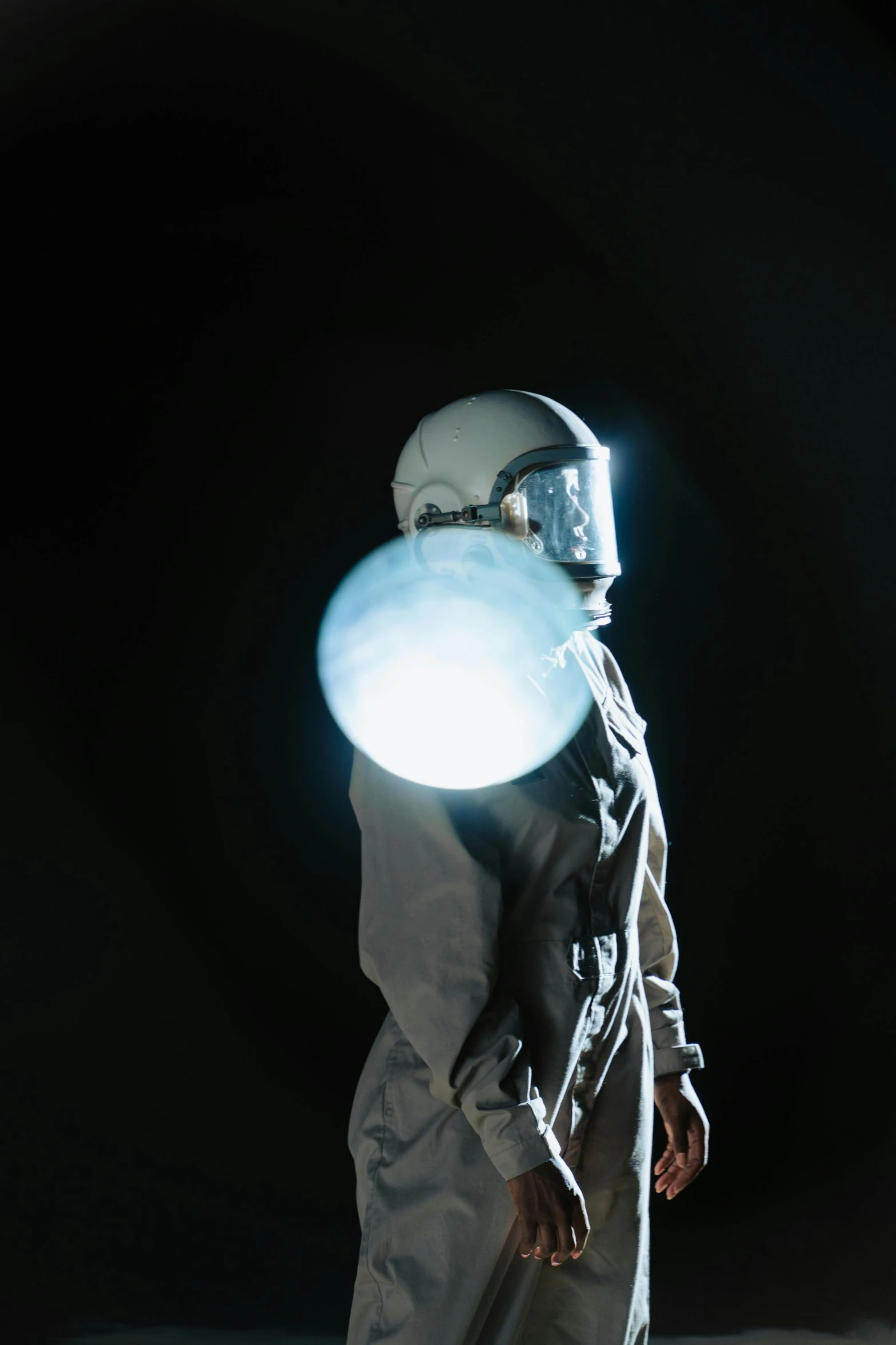 a man in a space suit holding a frisbee, inspired by Jeremy Geddes, unsplash, light and space, drag light bombs, photographed for reuters, “diamonds, maschinen krieger