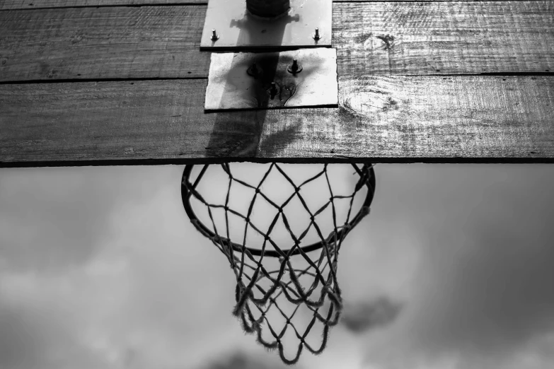 a black and white photo of a basketball hoop, a black and white photo, lace web, a wooden, lowres, playing