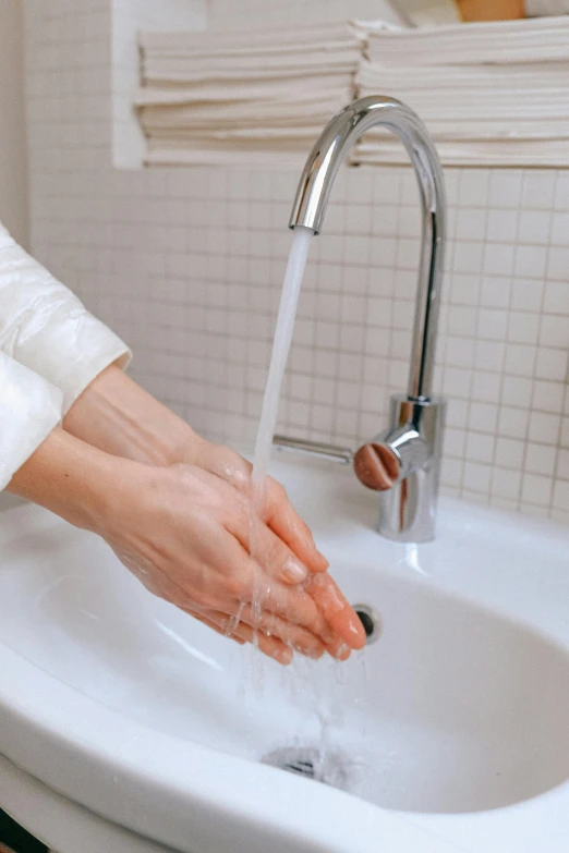 a person washing their hands in a sink, trending on pexels, hydration, ilustration, nursing, rivulets