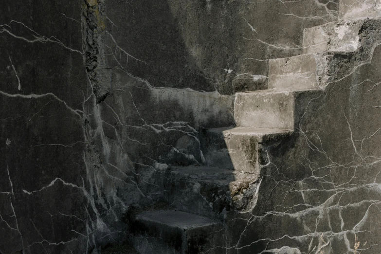 a white toilet sitting inside of a bathroom next to a wall, an album cover, inspired by Jan Lievens, unsplash contest winner, concrete art, stone stairway, detailed with shadows, black marble, ignant