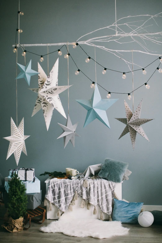 a room with a bunch of paper stars hanging from the ceiling, light and space, blue