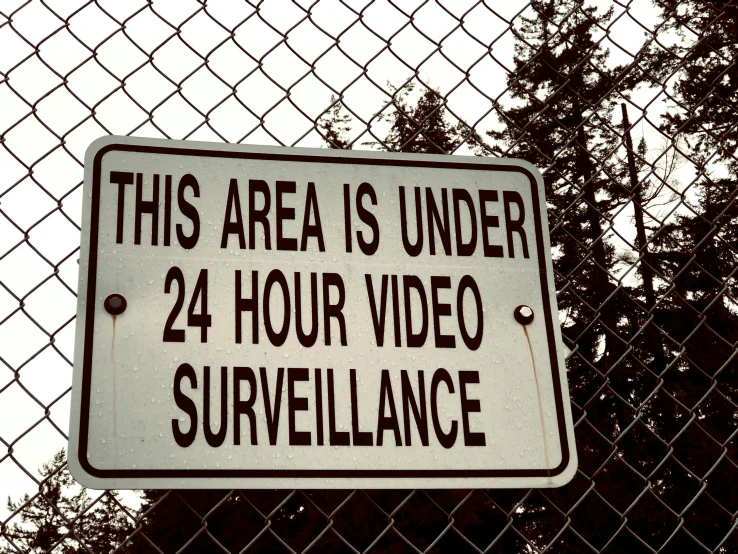 this area is under 24 hour video surveillance sign, by Everett Warner, shutterstock, graffiti, still frame the retro twin peaks, police state, holga, in a suburban backyard