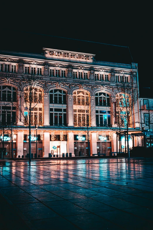 a building that is lit up at night, a colorized photo, pexels contest winner, art nouveau, mall, hannover, moody iconic scene, gif