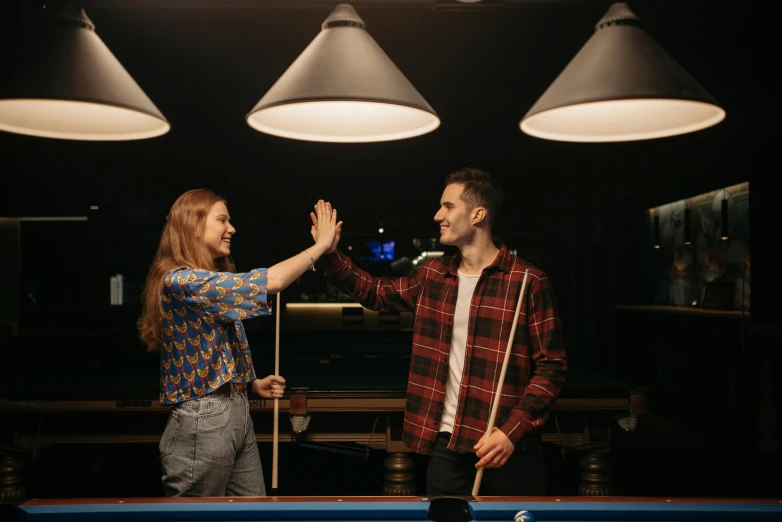 a man and a woman standing next to a pool table, pexels contest winner, waving, bisexual lighting, 15081959 21121991 01012000 4k, high quality photo