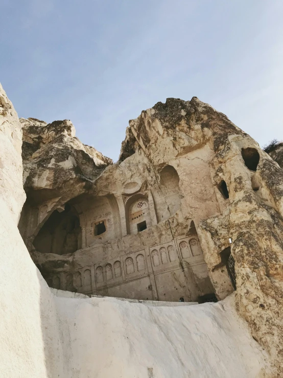 a building built into the side of a mountain, a marble sculpture, by Muggur, with great domes and arches, set photo, multiple stories, mid shot photo