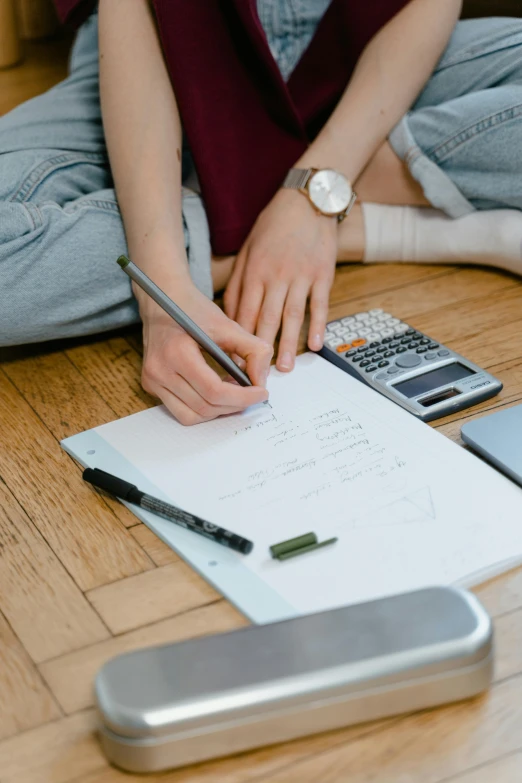 a woman sitting on the floor writing on a piece of paper, trending on pexels, analytical art, balancing the equation, medium shot of two characters, 15081959 21121991 01012000 4k, casey cooke