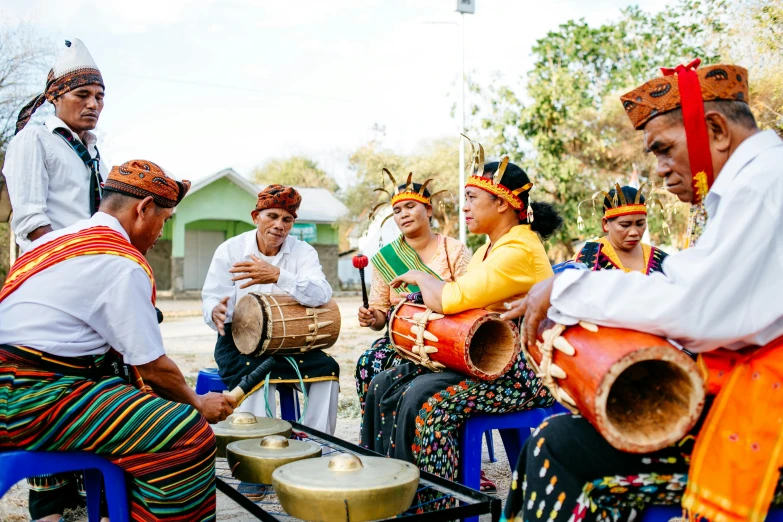 a group of people sitting around a drum, pexels contest winner, sumatraism, avatar image, instagram post, wearing authentic attire, real sousaphones