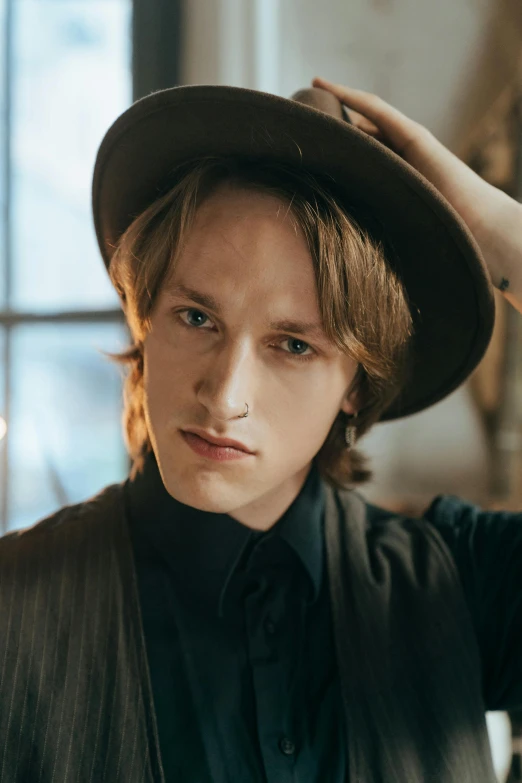 a close up of a person wearing a hat, an album cover, inspired by Illarion Pryanishnikov, trending on pexels, renaissance, attractive androgynous humanoid, actor, casual pose, linus sebastian