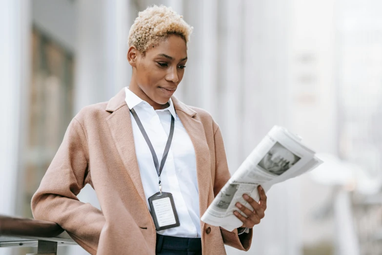 a woman standing on a balcony reading a newspaper, trending on pexels, private press, trench coat and suit, photo of a black woman, close up of a blonde woman, librarian