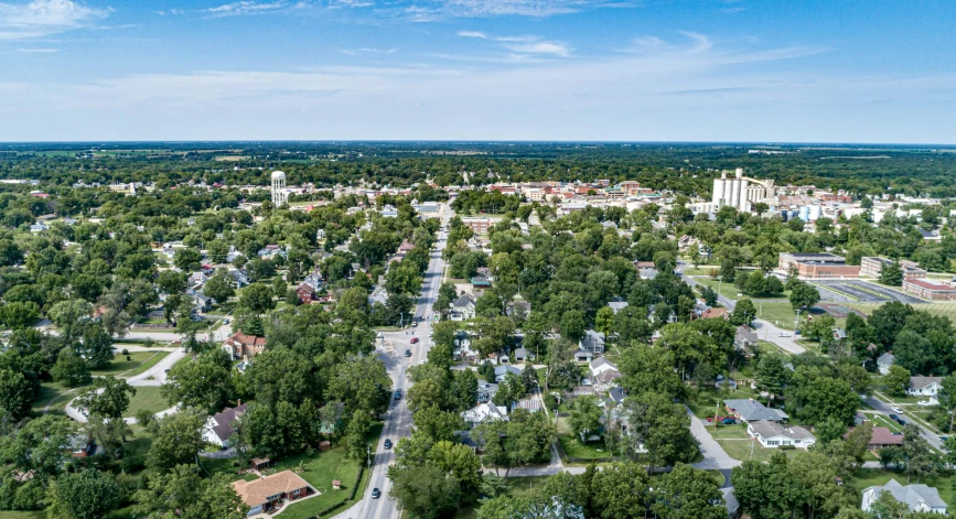 an aerial view of a town surrounded by trees, a portrait, by Winona Nelson, shutterstock, from wheaton illinois, ultrawide angle cinematic view, tall broad oaks, chesterfield