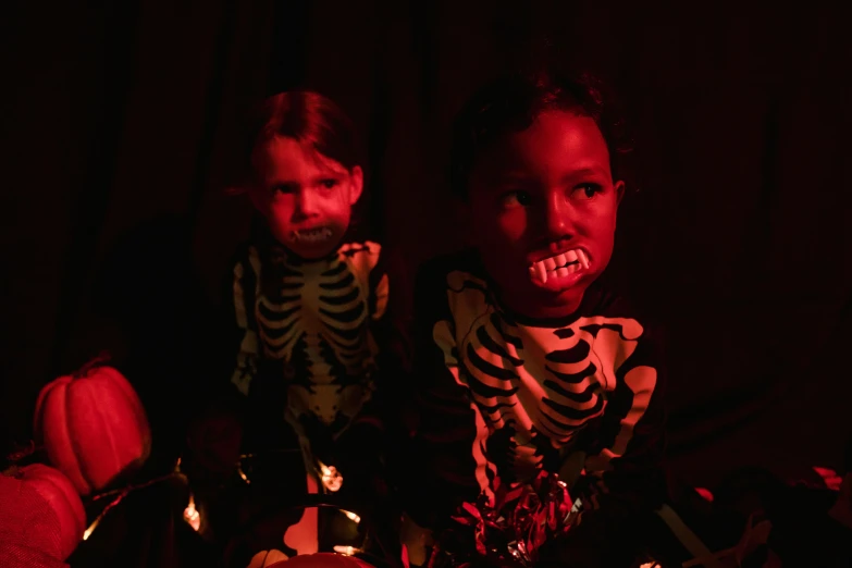 a couple of kids sitting next to each other, vanitas, glowing-eyes-and-mouth, taken with sony alpha 9, glowing bones, ( ( dark skin ) )