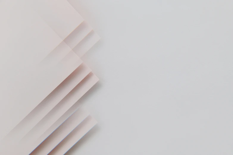 a close up of a sheet of paper on a table, unsplash, plasticien, light pink mist, light grey background, square lines, ignant