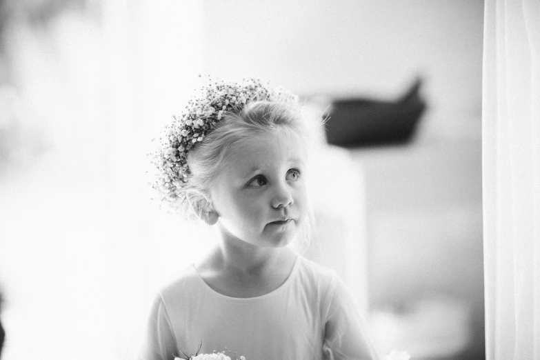 a black and white photo of a little girl holding a cake, by Jaakko Mattila, pexels, romanticism, gypsophila, in church, beautiful faces, wedding