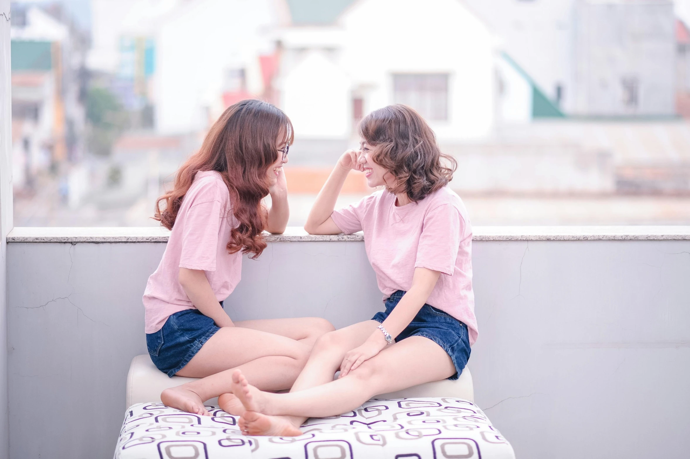 a couple of women sitting on top of a bed, by Tan Ting-pho, pexels contest winner, pink shirt, teenager hangout spot, 15081959 21121991 01012000 4k, wearing shorts and t shirt