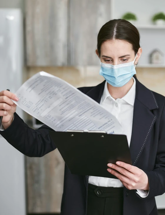 a woman wearing a face mask and holding a clipboard, by Julia Pishtar, pexels contest winner, lawyer suit, made of lab tissue, thumbnail, multiple stories