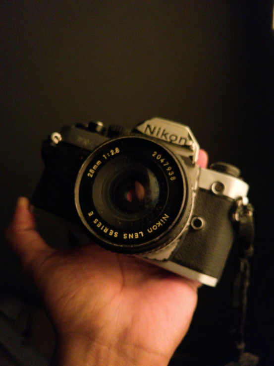 a person holding a camera in their hand, inspired by Elsa Bleda, art photography, with nikon cameras, 35mm 1990, ansel ]