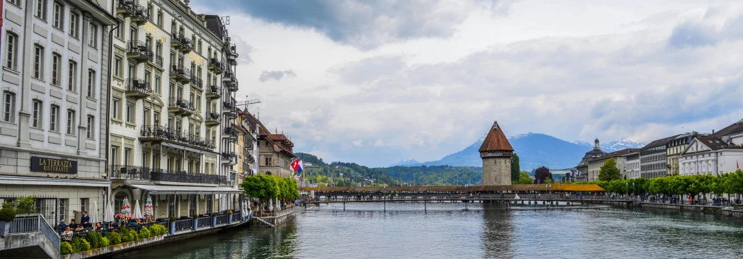a river running through a city next to tall buildings, pexels contest winner, renaissance, swiss architecture, on a lake, turrets, youtube thumbnail