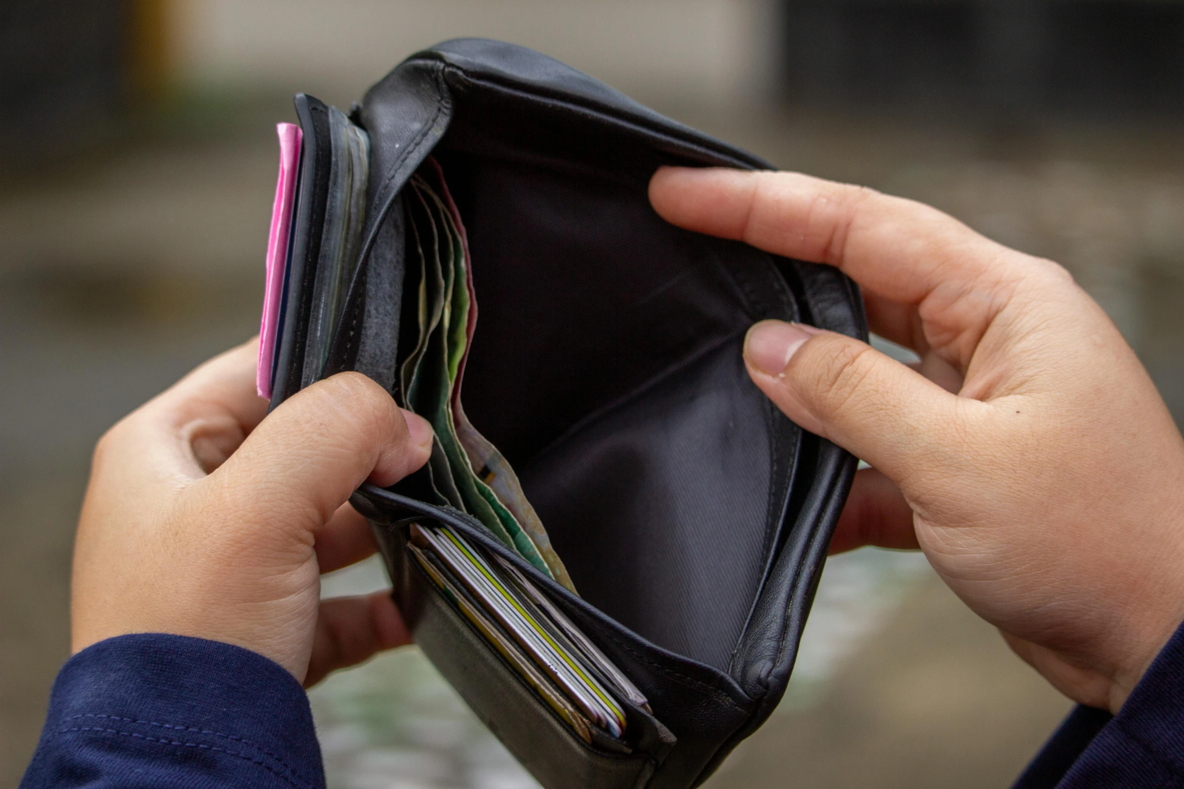 a close up of a person holding a wallet, happening, taken from the high street, square, press shot, concern