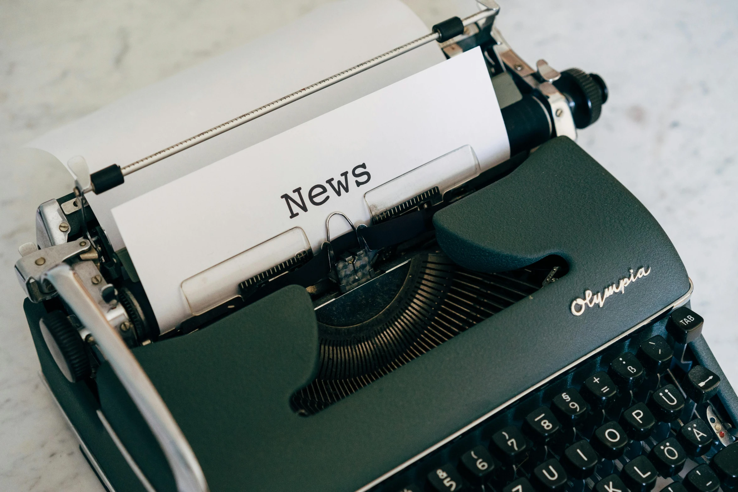 a close up of a typewriter on a table, a cartoon, trending on pexels, private press, evening news program, ivy's, a new, background image