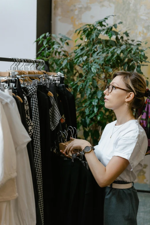 a woman standing in front of a rack of clothes, inspect in inventory image, foliage clothing, gif, commercially ready