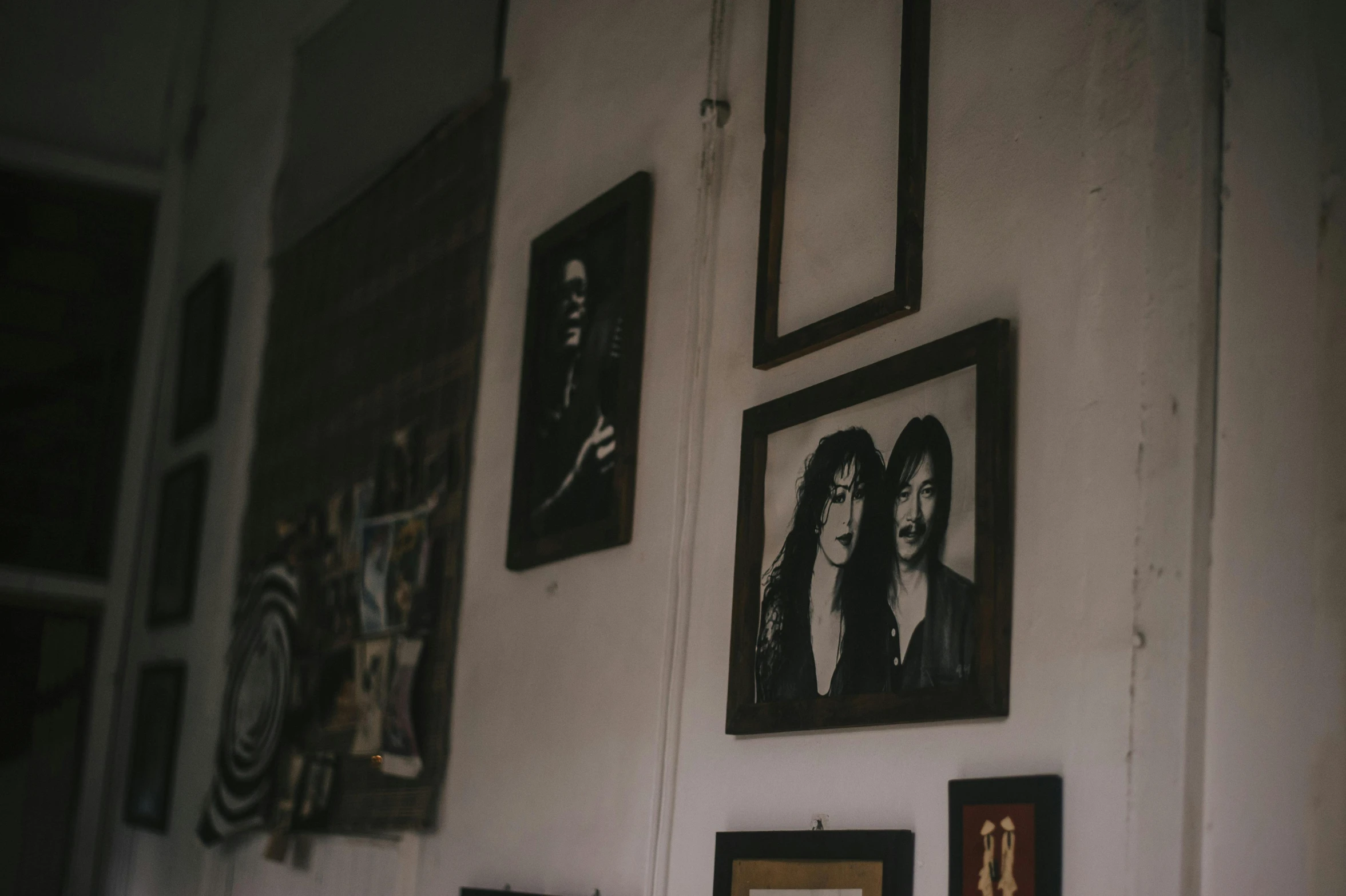 a wall that has a bunch of pictures on it, pexels contest winner, visual art, portrait of two people, guitarists, with his long black hair, private collection