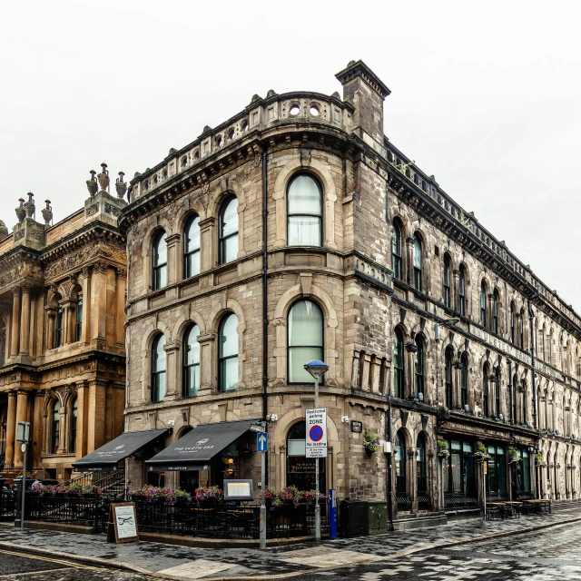 a large building sitting on the side of a street, renaissance, paisley, overcast mood, lush, bath