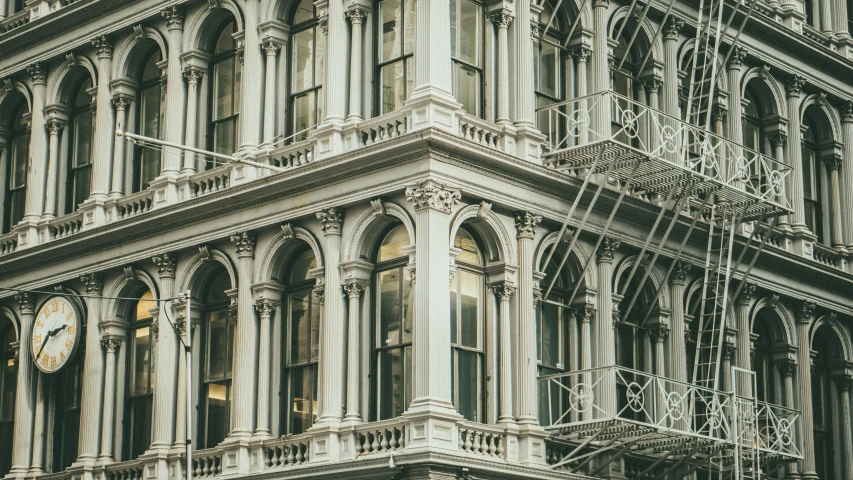 a clock that is on the side of a building, a photo, inspired by Elsa Bleda, pexels contest winner, art nouveau, new york buildings, stacked image, victorian architecture, intricate ”