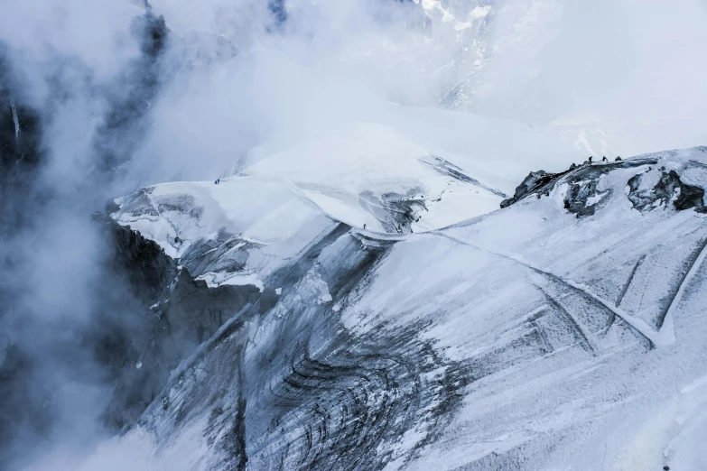 a man standing on top of a snow covered mountain, by Peter Churcher, pexels contest winner, visual art, glaciers, texture detail, cold mist black background, photograph from above