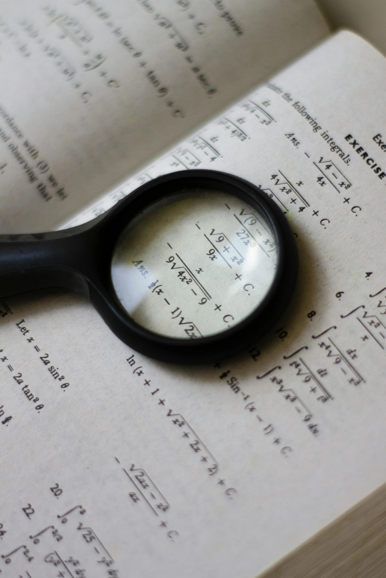 a magnifying glass sitting on top of an open book, equations, up close, complex structures, nerds