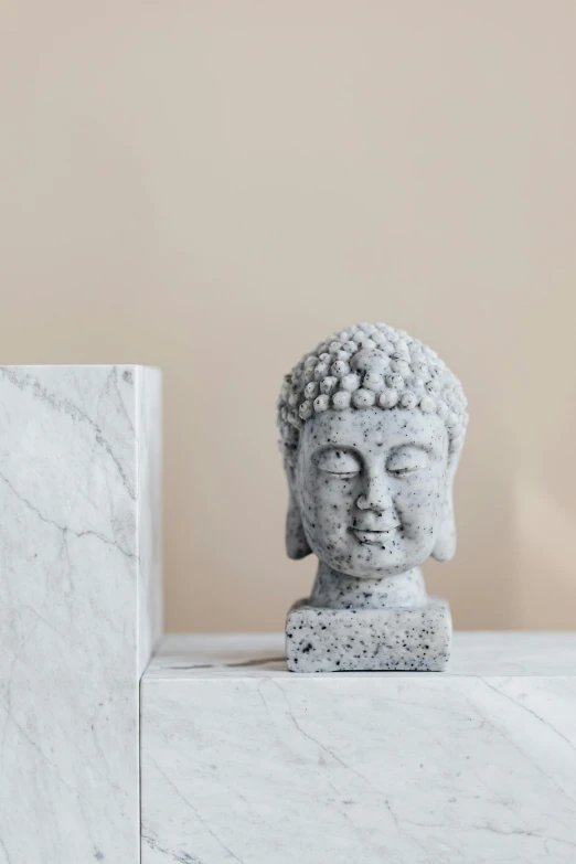 a close up of a statue on a shelf, a marble sculpture, inspired by Kaigetsudō Ando, trending on unsplash, concrete art, square face, health spa and meditation center, official product photo, full face frontal centered