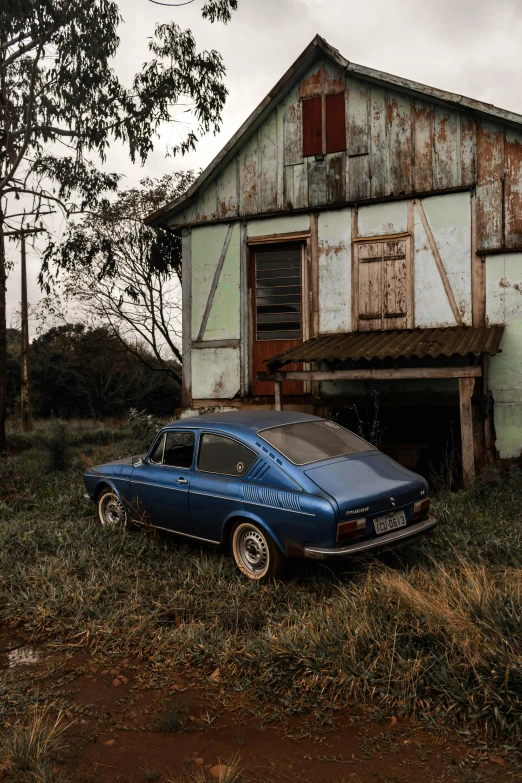 a blue car parked in front of a house, an album cover, by Elsa Bleda, unsplash contest winner, photorealism, in an abandoned barn, brazil, 🚿🗝📝, renault ultimo