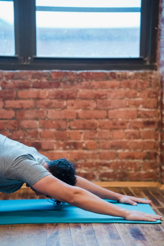 a man doing a yoga pose in front of a window, by Carey Morris, promo image, boston, panoramic shot, head down
