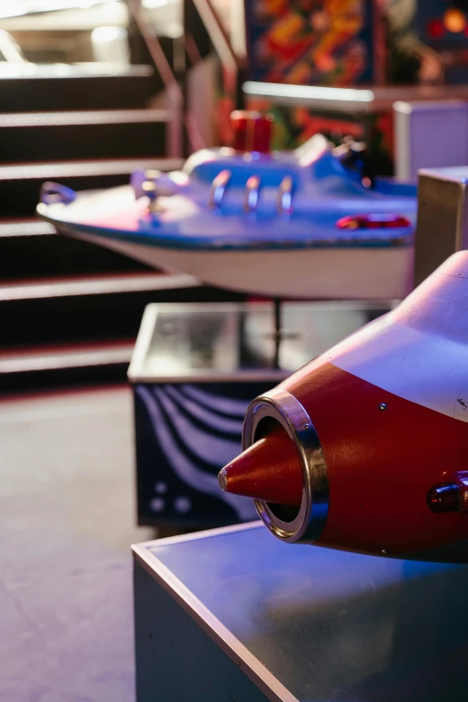 a model airplane sitting on top of a table, at inside of a future submarine, thunderbirds, rocket ship, vibrant colour