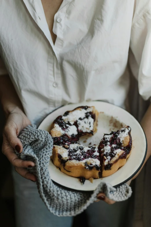 a close up of a person holding a plate of food, a still life, by Anna Haifisch, trending on unsplash, powdered sugar, pie eyes, blueberry, cozy