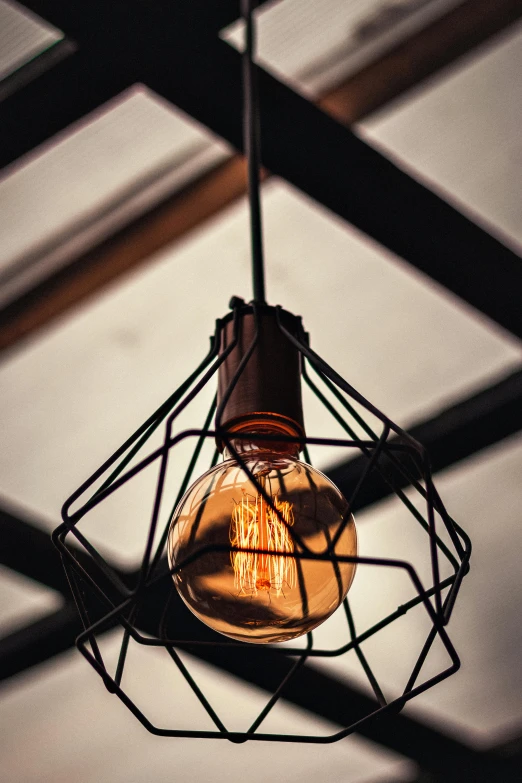 a light bulb hanging from the ceiling of a building, pexels contest winner, light and space, rustic, warmly lit, dynamic closeup