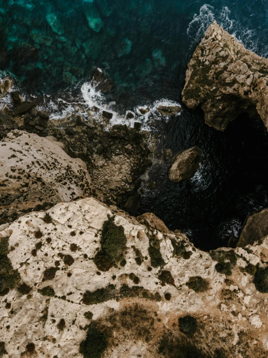 a man standing on top of a rock next to the ocean, pexels contest winner, les nabis, top view of convertible, standing in a grotto, overwhelming depth and detail, cyprus