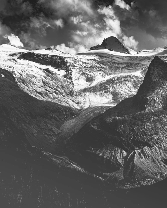 a black and white photo of a mountain range, glacier landscape, british columbia, high-contrast, the middle of a valley