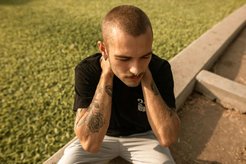 a man sitting on a bench talking on a cell phone, a tattoo, pexels contest winner, he is wearing a black t-shirt, hear no evil, avatar image, focused on neck