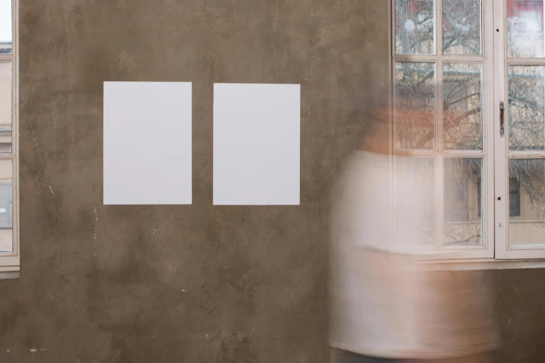 a blurry image of a person standing in front of a window, a minimalist painting, inspired by Agnes Martin, trending on unsplash, placards, hyper realistic photorealistic, blank paper, floating ghost