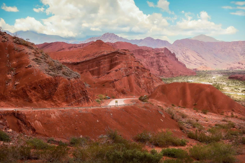 a dirt road in the desert with mountains in the background, inspired by Steve McCurry, pexels contest winner, 8 k very red colors, andes, panoramic, 000 — википедия