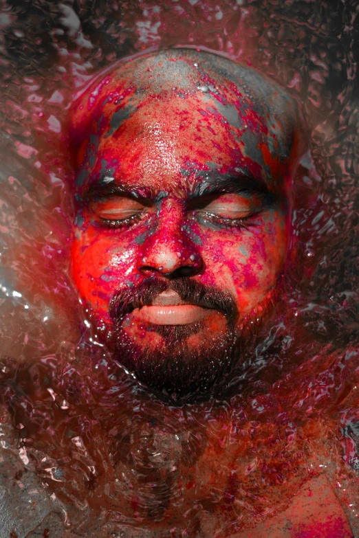 a man with red paint on his face in the water, an album cover, inspired by Steve McCurry, pexels contest winner, process art, aboriginal australian hipster, wet hairy bodies, garnet, 2 0 1 0 s