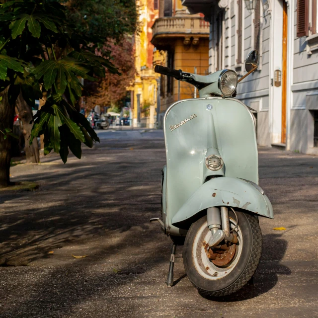 a scooter parked on the side of a street, by Carlo Maderna, preserved historical, grey, fan favorite, blue