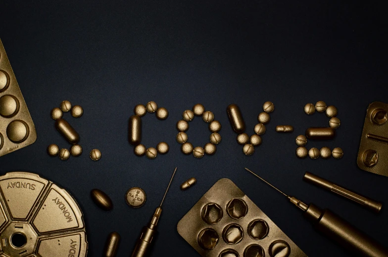 a bunch of pills sitting on top of a table, an album cover, by Bascove, pexels contest winner, excessivism, brown and gold, surgical implements, typographic, love moive